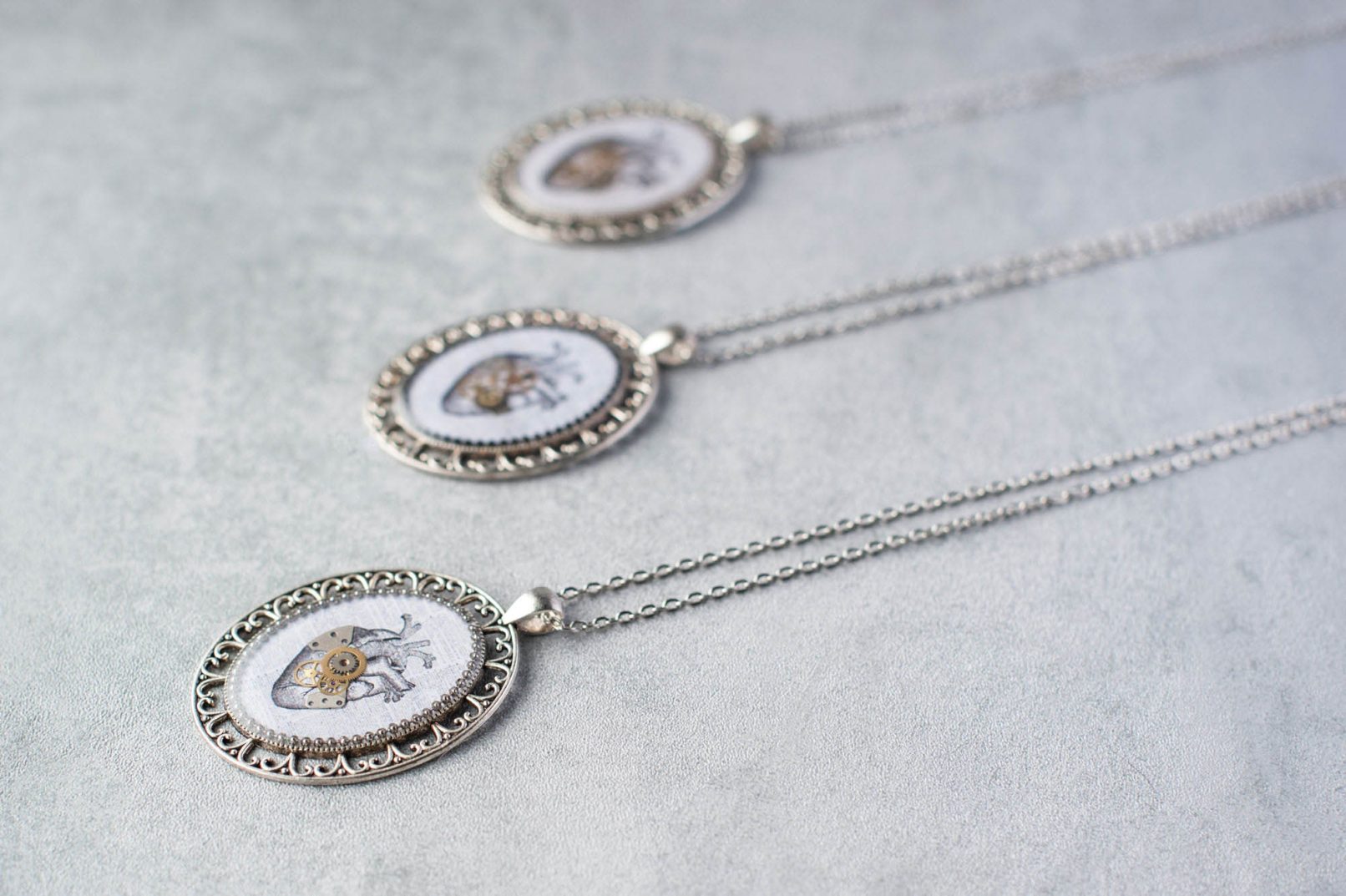 Steampunk necklaces with authentic watch parts and vintage illustrations of anatomical hearts