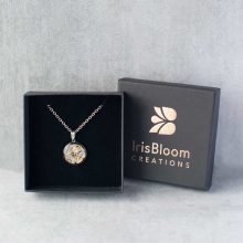 Round steampunk necklace made with watch parts in a jewellery box