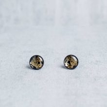 Black mechanical stud earrings featuring authentic watch gears.