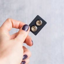 Black steampunk studs crafted from reclaimed watch parts