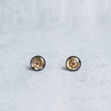 Handmade black stud earrings with vintage watch parts embedded inside.