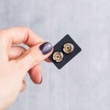 Black steampunk earrings with small gears and mechanical parts.