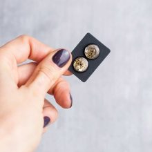 Black resin steampunk earrings with reclaimed watch mechanisms.