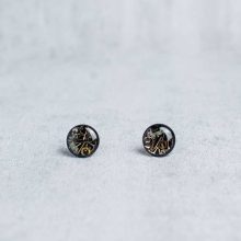 Black steampunk earrings with small gears and mechanical parts.