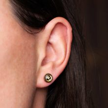 Handmade steampunk earrings worn on ear