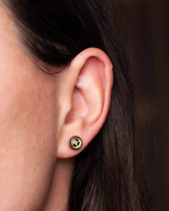 Handmade steampunk earrings worn on ear