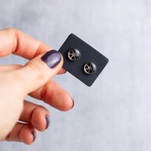 Silver minimalist steampunk earrings on card held in hand, 6mm