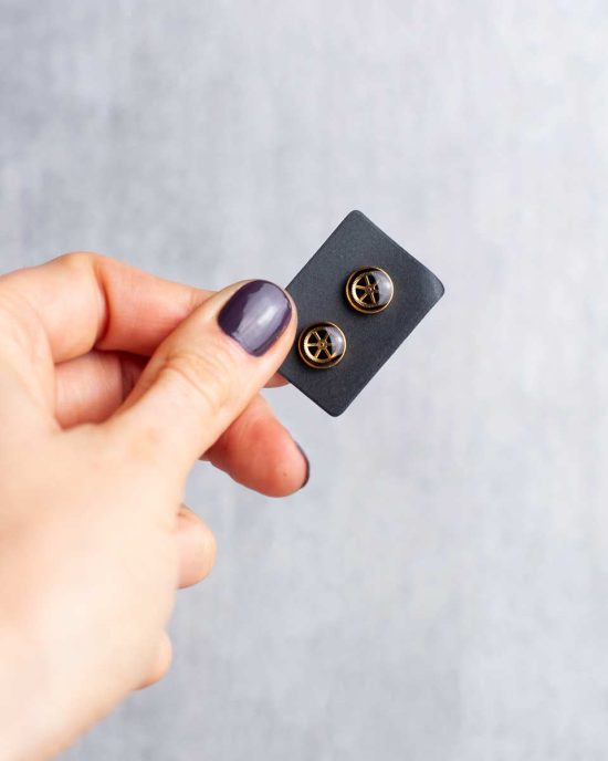 Gold Elemental earrings on display card held in hand, 8mm