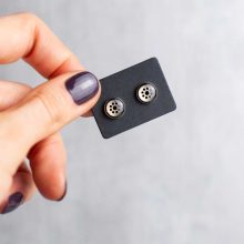 Silver minimalist steampunk earrings on card held in hand, 6mm