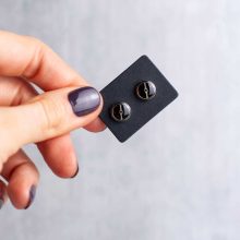 Silver minimalist steampunk earrings on card held in hand, 6mm