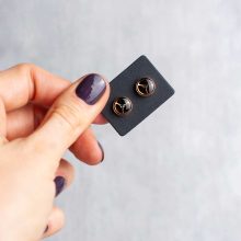 Unique stainless steel steampunk earrings in rose gold on a card