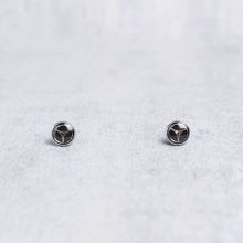 Silver minimalist steampunk earrings on card held in hand, 6mm
