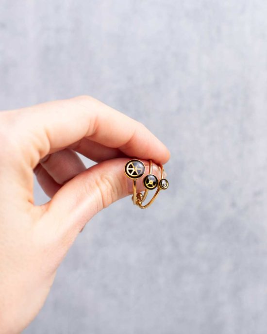 Small, minimalist steampunk rings in gold worn on hand