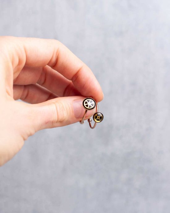 Small, minimalist steampunk rings in gold worn on hand