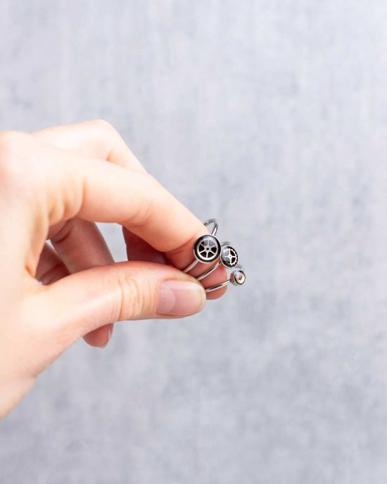Small, minimalist steampunk rings in silver worn on hand