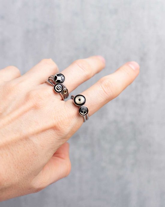 Small, minimalist steampunk rings in silver worn on hand